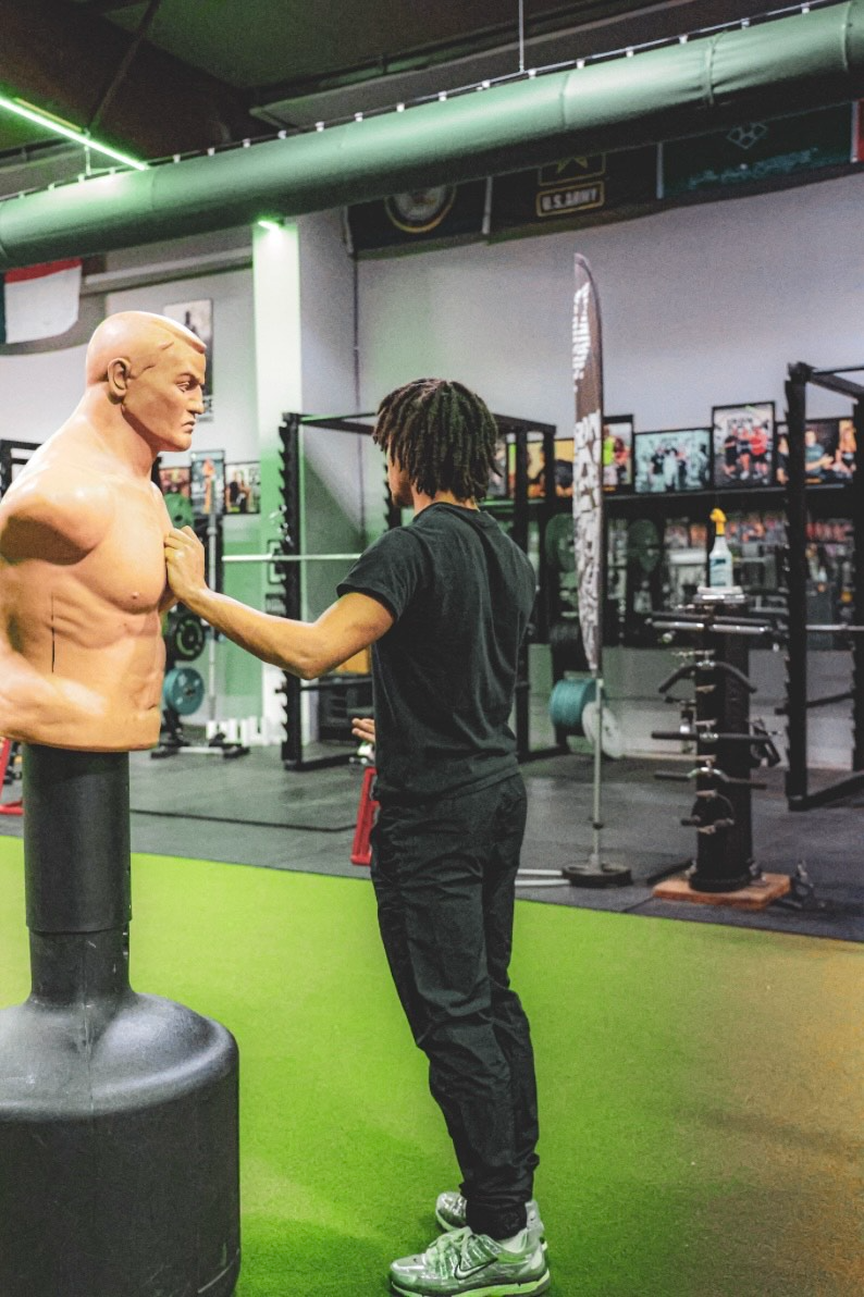DUB Athletic athlete training against a football dummy
