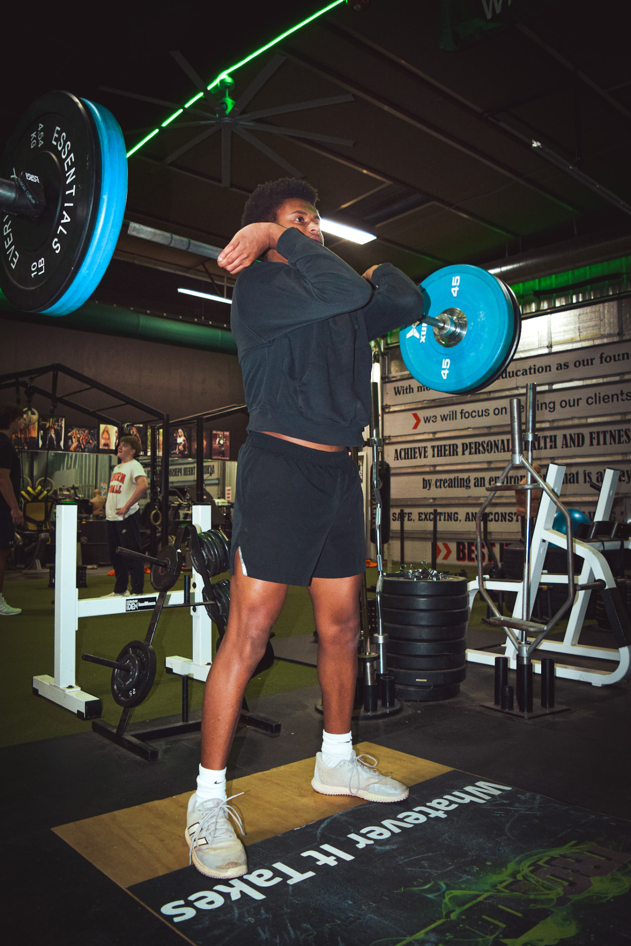 DUB Athletic athlete holding a front squat position under a loaded barbell