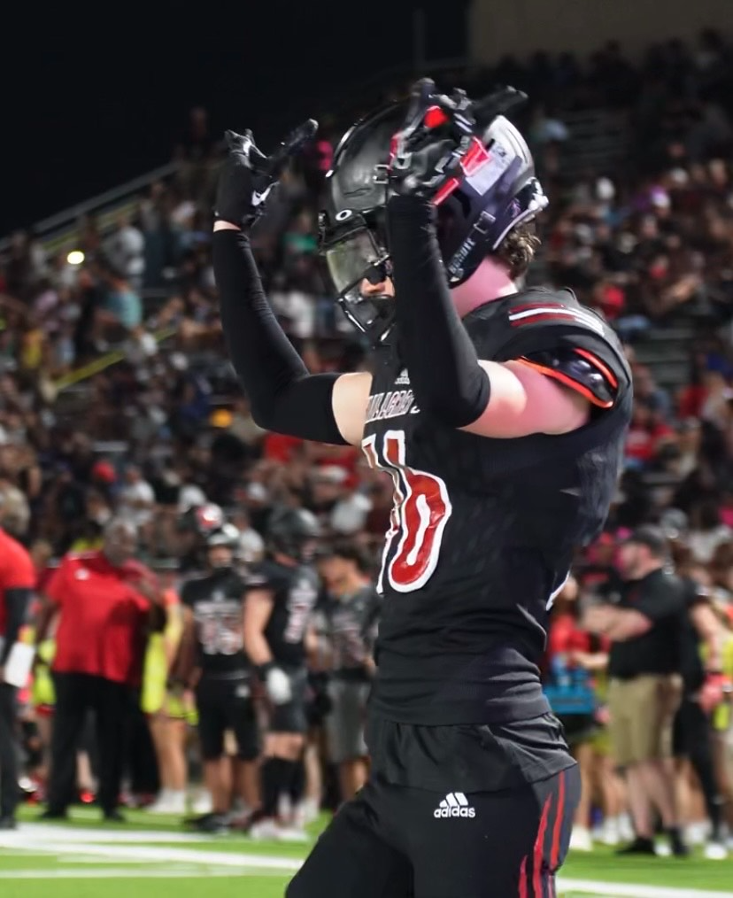 Football player wearing number 10 celebrating at night