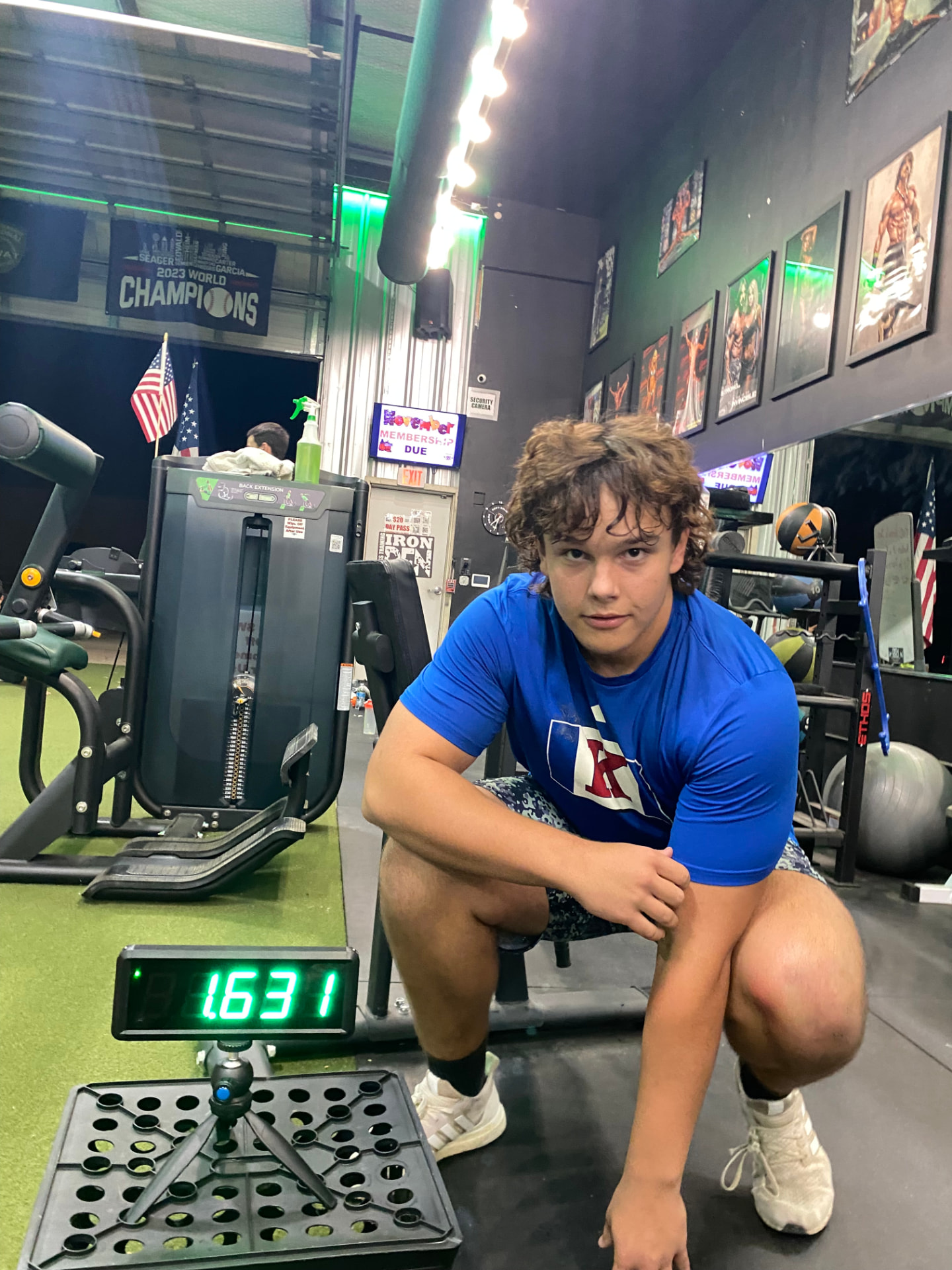 DUB Athletic athlete squatting under a barbell beside a training timer