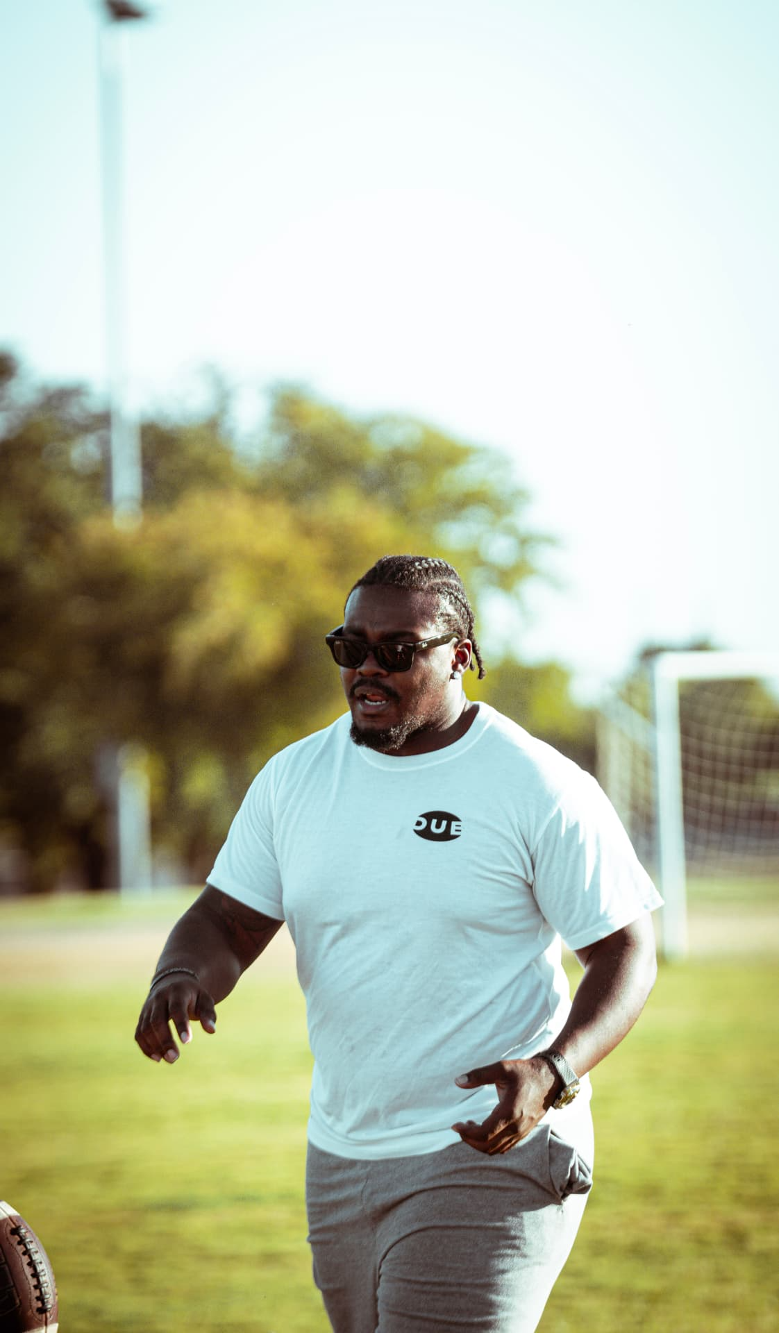 DUB Athletic coach in a white DUB shirt and sunglasses outdoors