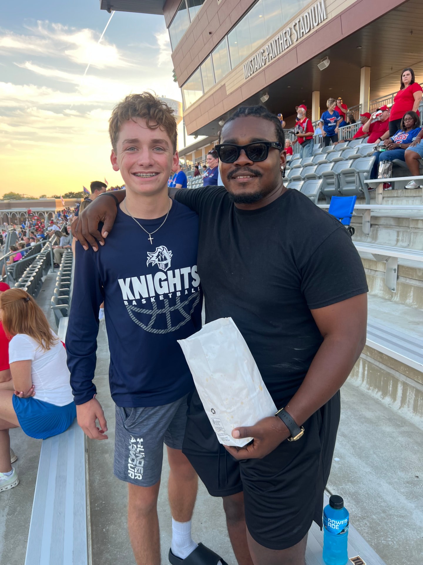 DUB Athletic coach and athlete together at a stadium